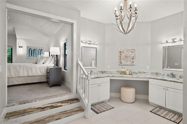 bathroom featuring vaulted ceiling, vanity, a chandelier, and a textured ceiling