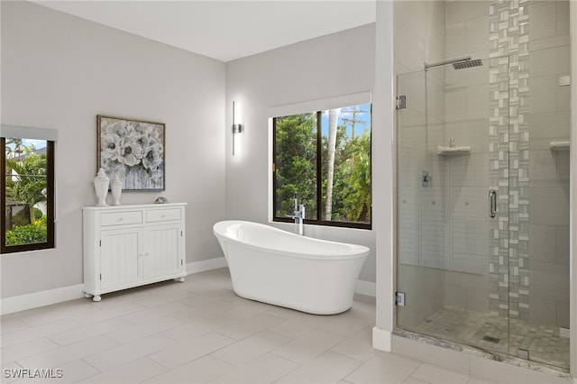 bathroom with tile patterned flooring and separate shower and tub