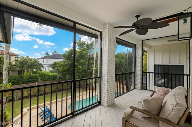 sunroom / solarium with ceiling fan