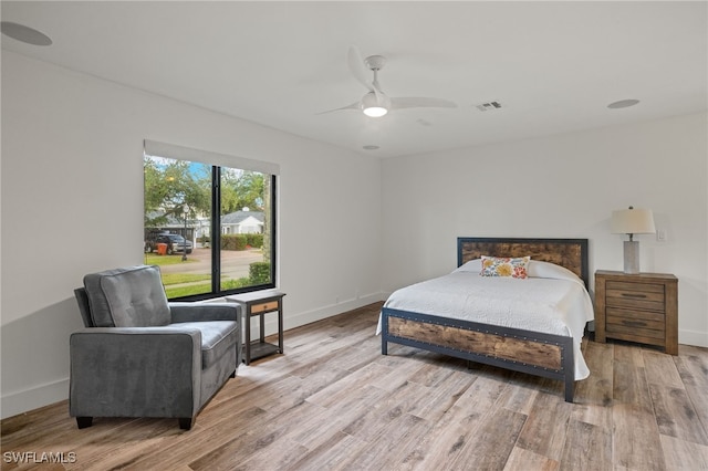 bedroom with light hardwood / wood-style flooring and ceiling fan