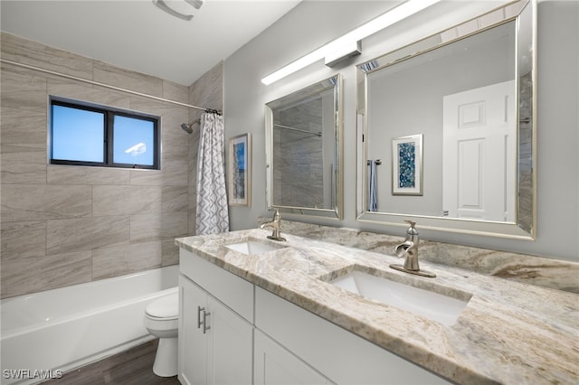 full bathroom with hardwood / wood-style floors, vanity, toilet, and shower / bath combo with shower curtain