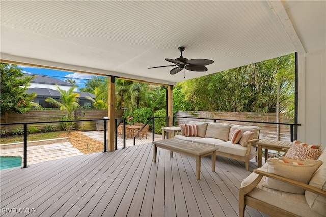 wooden terrace with an outdoor living space and ceiling fan