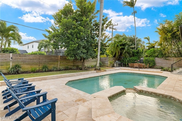 view of pool with an in ground hot tub and a patio