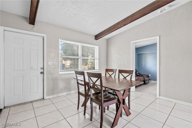 dining space with lofted ceiling with beams, light tile patterned flooring, and a textured ceiling