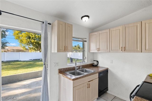 kitchen with light brown cabinets, sink, black dishwasher, and vaulted ceiling