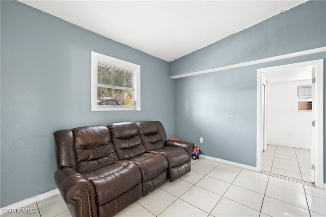 living room featuring light tile patterned floors and vaulted ceiling