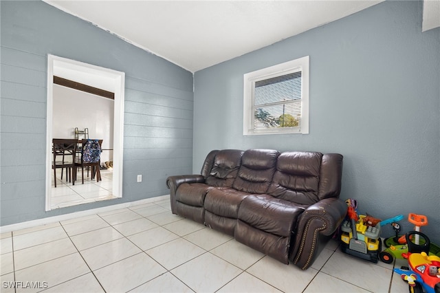 tiled living room featuring lofted ceiling