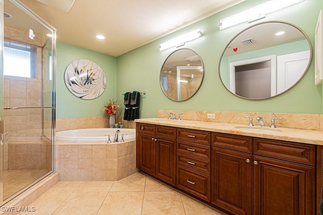 bathroom with tile patterned floors, vanity, and shower with separate bathtub