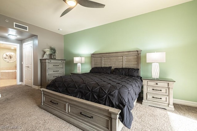 bedroom featuring connected bathroom, ceiling fan, and light carpet