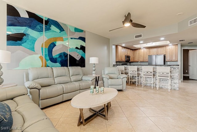 living room featuring ceiling fan and light tile patterned floors