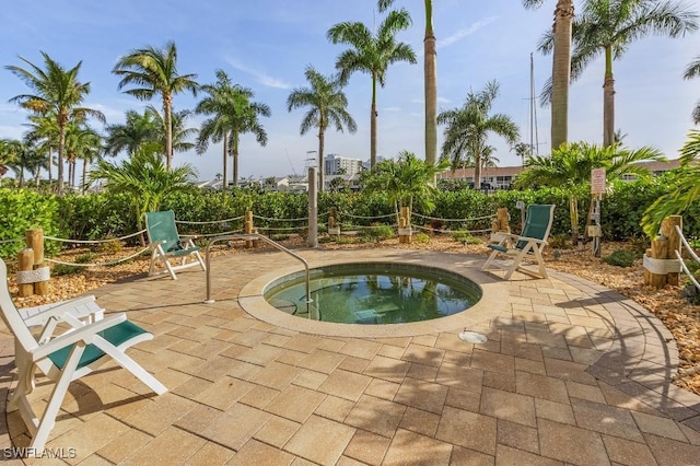 view of swimming pool featuring an in ground hot tub and a patio area