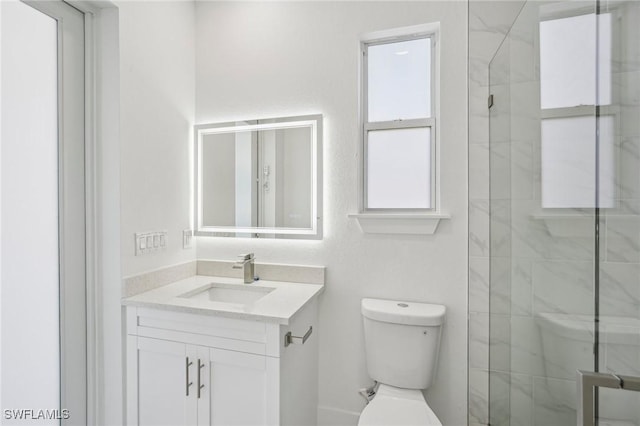 bathroom with vanity, toilet, and walk in shower