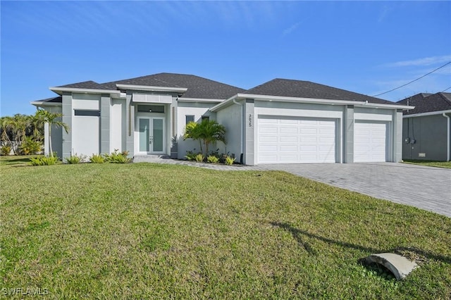 view of front of home with french doors, a garage, and a front lawn