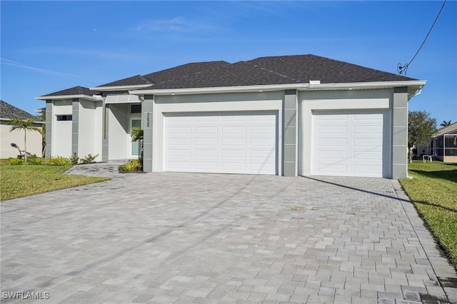 view of front of home featuring a garage and a front lawn