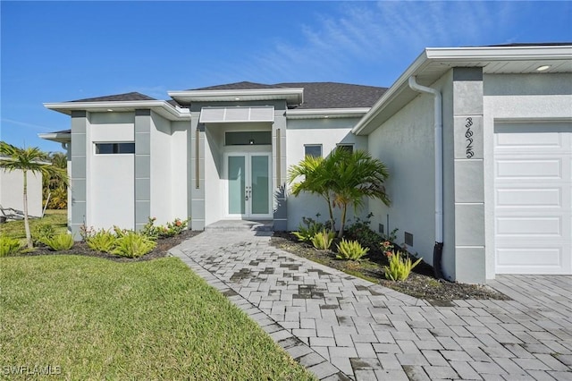 entrance to property with a lawn and a garage