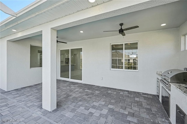 view of patio / terrace with a grill, area for grilling, and ceiling fan