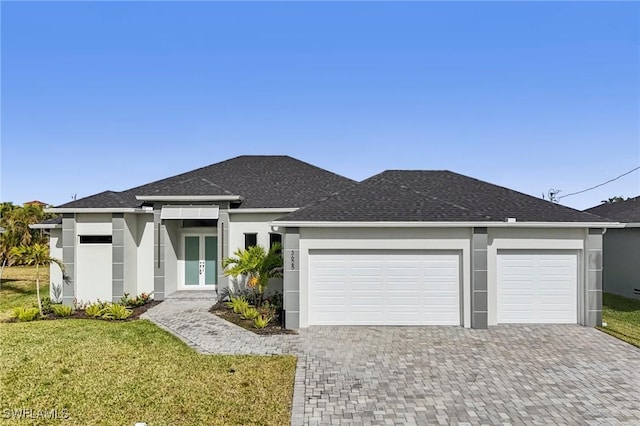 prairie-style home with a garage and a front yard