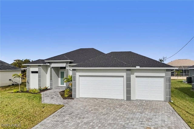 view of front of house featuring a garage and a front lawn