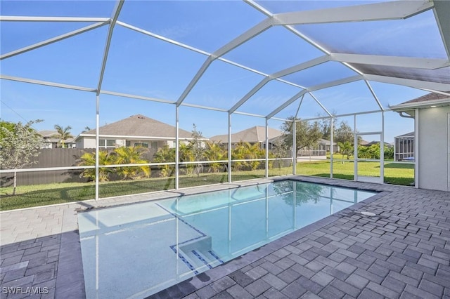 view of pool featuring a lanai, a lawn, and a patio