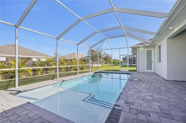 view of pool with a patio area and a lanai