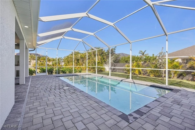 view of swimming pool with a patio and glass enclosure