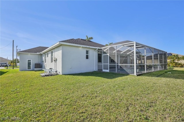 rear view of property featuring glass enclosure and a lawn