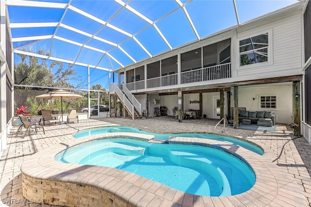 view of swimming pool with stairway, an outdoor hangout area, a sunroom, glass enclosure, and a patio area