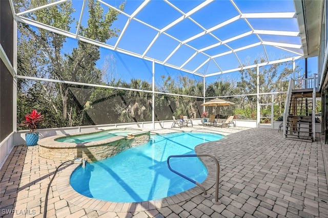 view of pool featuring a patio, stairway, a lanai, and a pool with connected hot tub