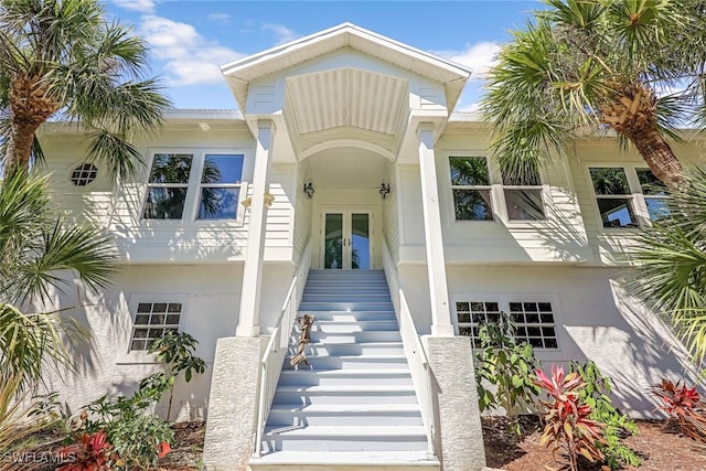 doorway to property with stucco siding