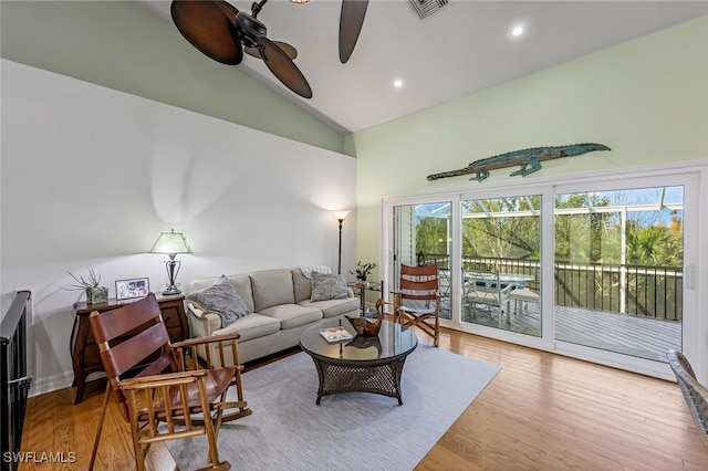 living room featuring visible vents, light wood-style flooring, ceiling fan, high vaulted ceiling, and recessed lighting