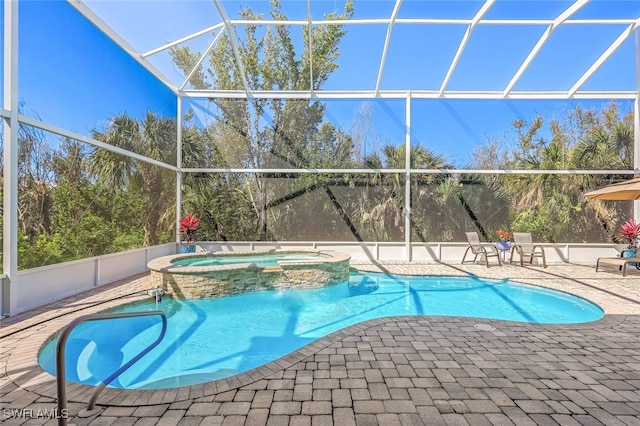 view of pool featuring a lanai, a pool with connected hot tub, and a patio