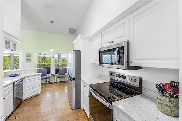 kitchen featuring stainless steel appliances, white cabinets, and visible vents