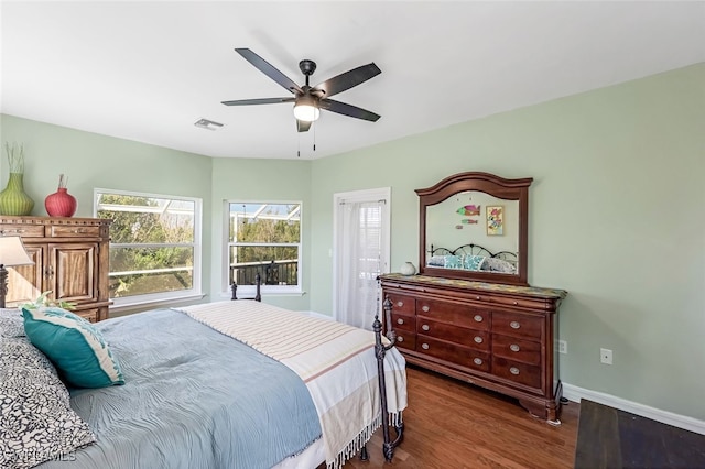 bedroom with a ceiling fan, baseboards, visible vents, and dark wood-style flooring