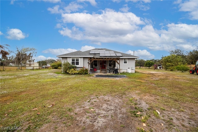 2915 Ortona Locks Rd, Moore Haven, FL 33471 - back of house featuring roof mounted solar panels, a patio, and a yard