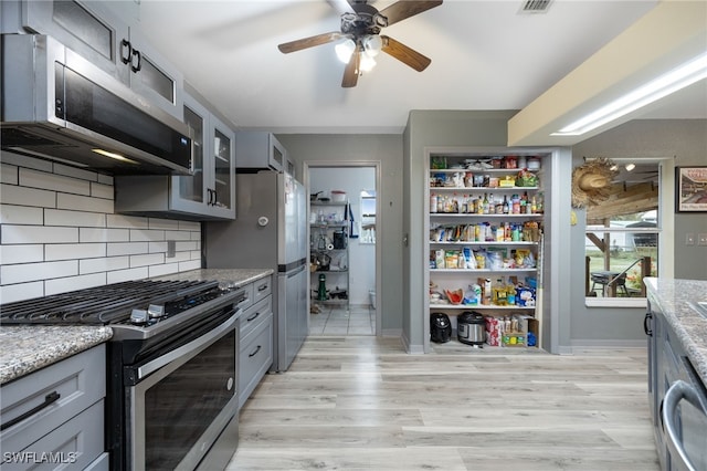 2915 Ortona Locks Rd, Moore Haven, FL 33471 - kitchen with appliances with stainless steel finishes, gray cabinets, ceiling fan, and light wood-style floors