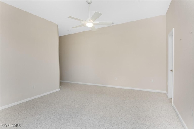 empty room with lofted ceiling, ceiling fan, and light colored carpet