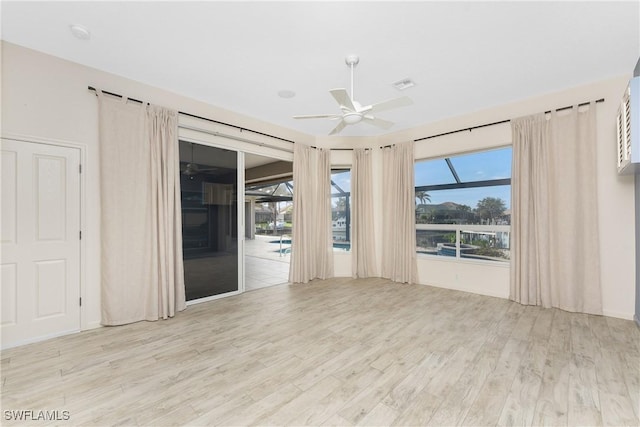 empty room featuring ceiling fan and light wood-type flooring