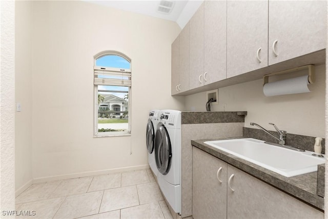 washroom featuring sink, cabinets, washer and dryer, and light tile patterned floors