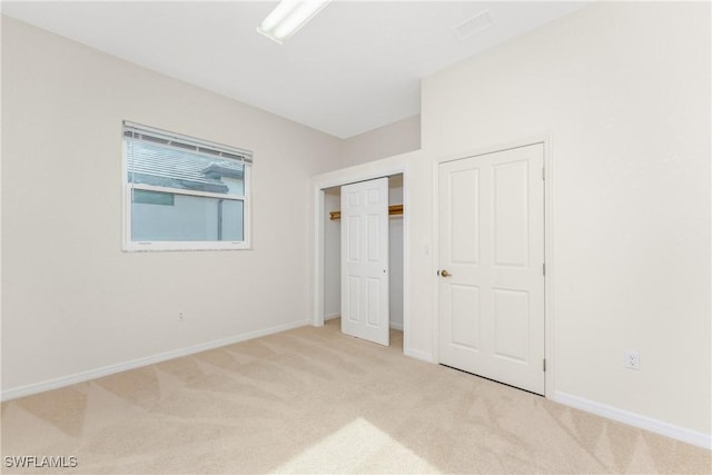 unfurnished bedroom featuring light colored carpet