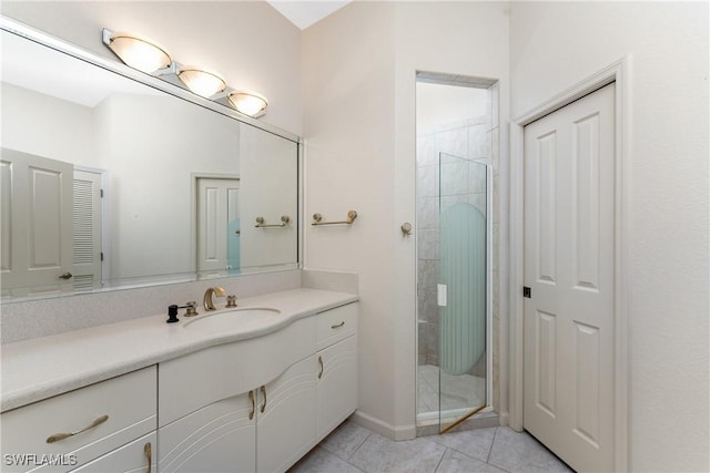 bathroom with a shower with door, tile patterned floors, and vanity