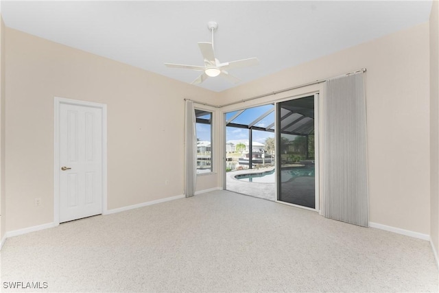 carpeted spare room featuring ceiling fan