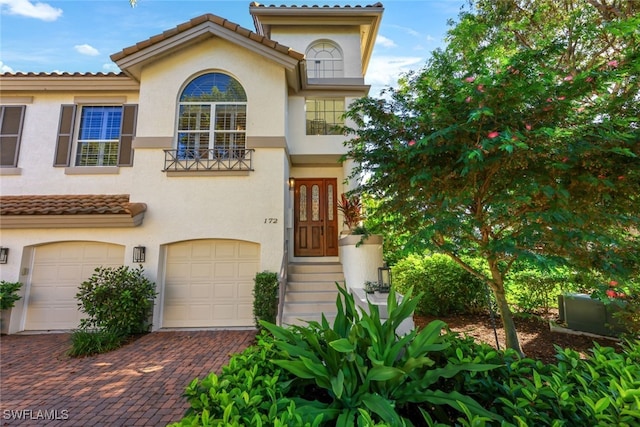 mediterranean / spanish-style house with a garage