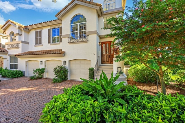 mediterranean / spanish-style home featuring a garage