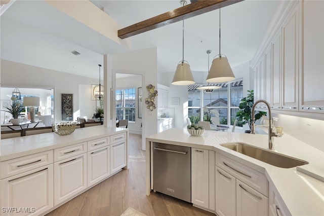 kitchen with white cabinetry, sink, hanging light fixtures, stainless steel dishwasher, and light hardwood / wood-style floors