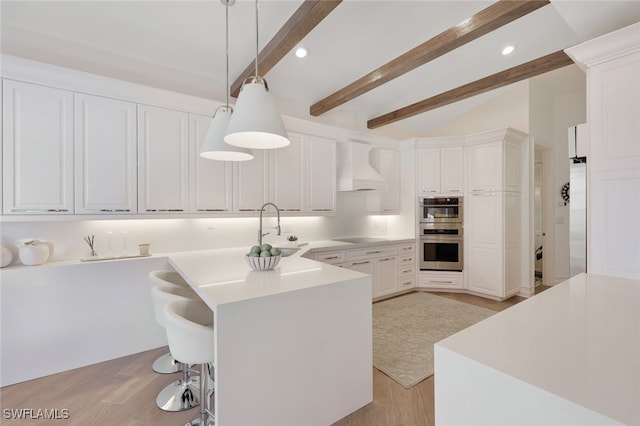 kitchen with premium range hood, white cabinets, decorative light fixtures, beam ceiling, and stainless steel appliances