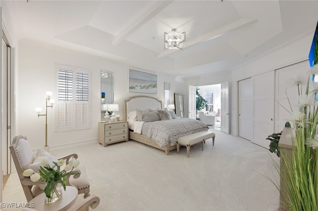 bedroom with a tray ceiling, light colored carpet, and ornamental molding