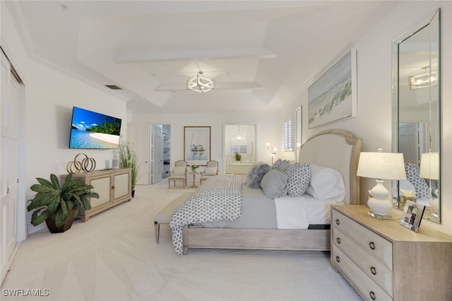 carpeted bedroom featuring a tray ceiling, ensuite bath, and ceiling fan