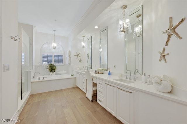 bathroom featuring independent shower and bath, vanity, and wood-type flooring