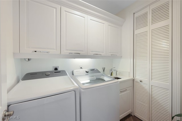 washroom featuring washer and dryer and cabinets