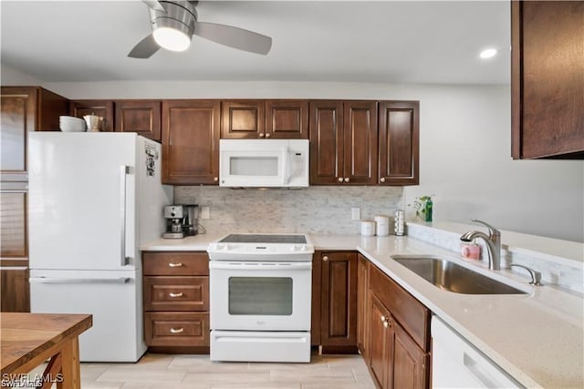 kitchen with ceiling fan, sink, tasteful backsplash, light stone counters, and white appliances